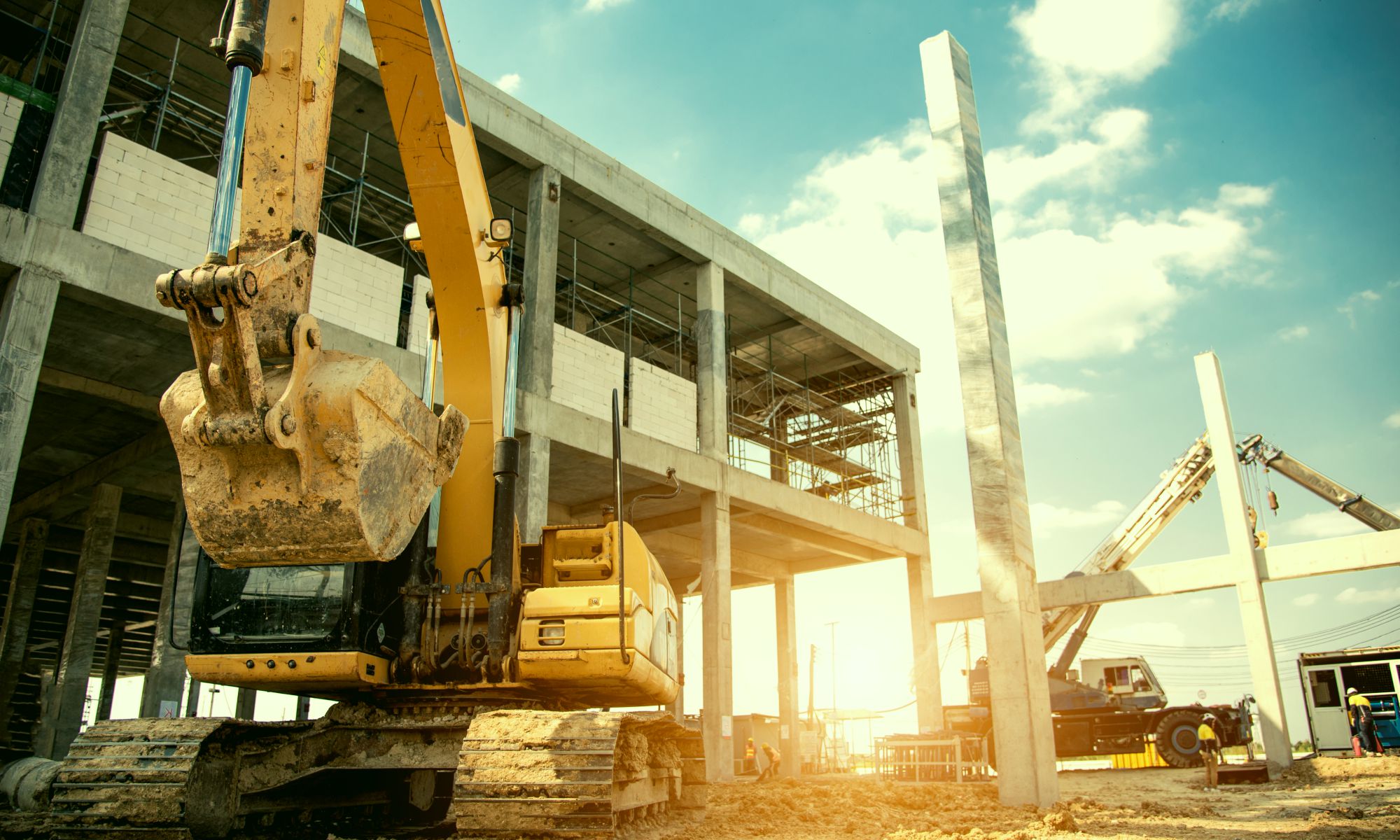 Excavator doing building erection and construction at power plant.