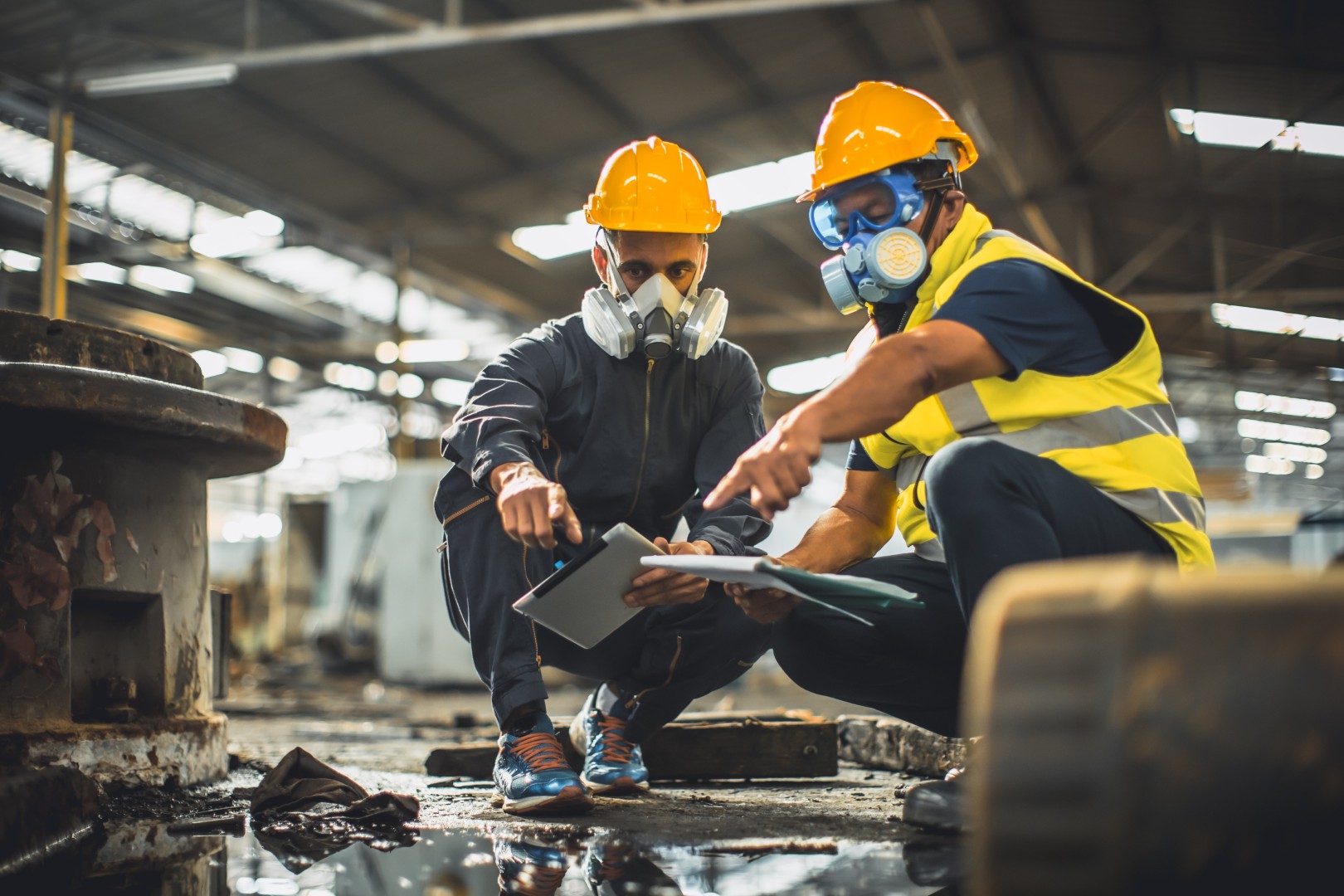 Two men doing waste profiling at industrial power plant. 